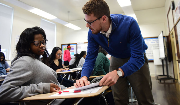 A Catholic University student gaining hands-on experience teaching in a high school classroom.
