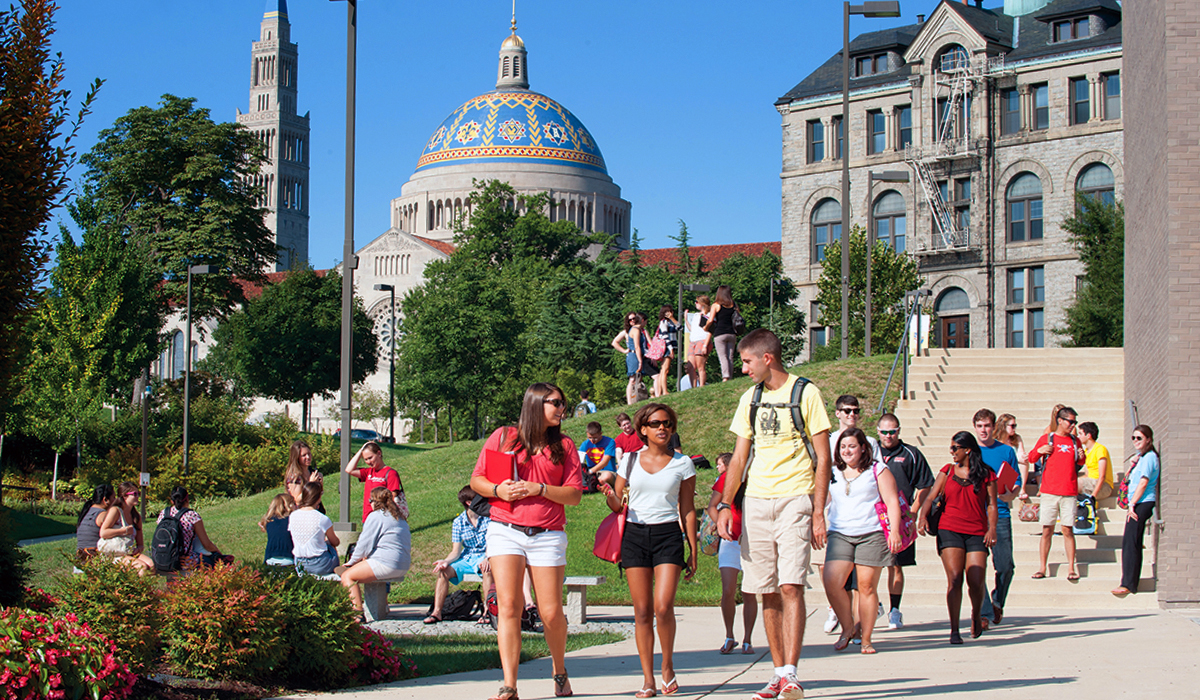 students walking on campus with the basilica dome in the background