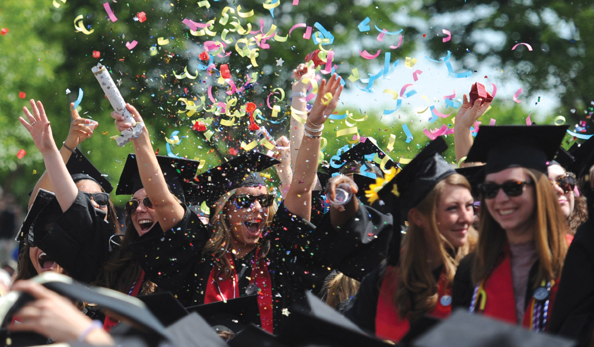 students celebrating with confetti at graduation