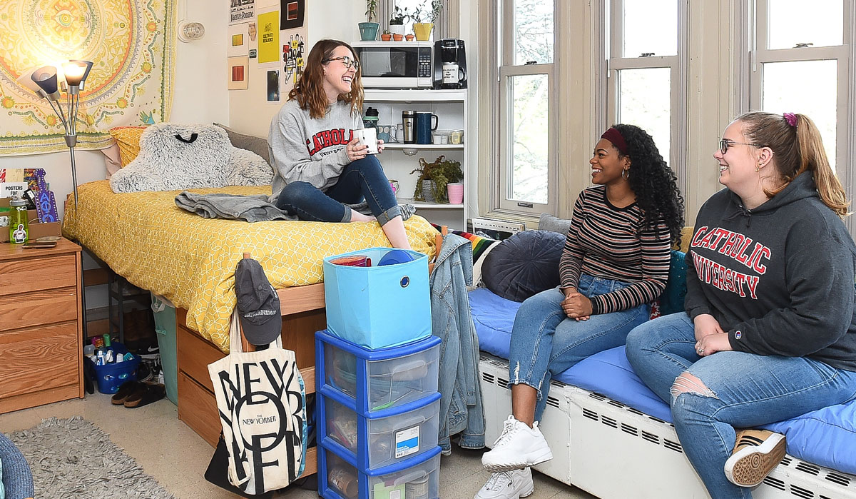 Three female students in residence hall room
