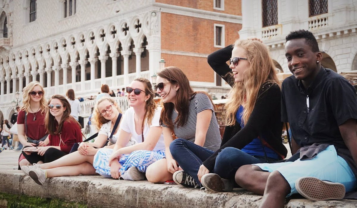 Student sitting in Roman piazza 