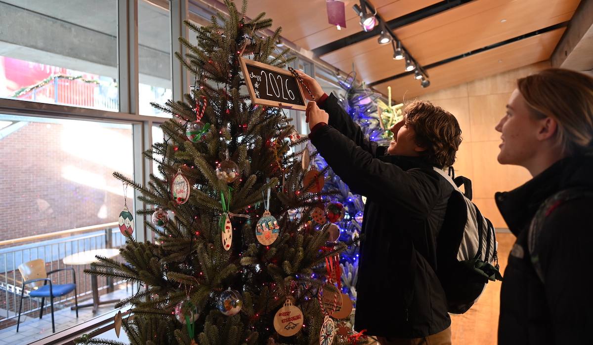 student decorating a Christmas tree
