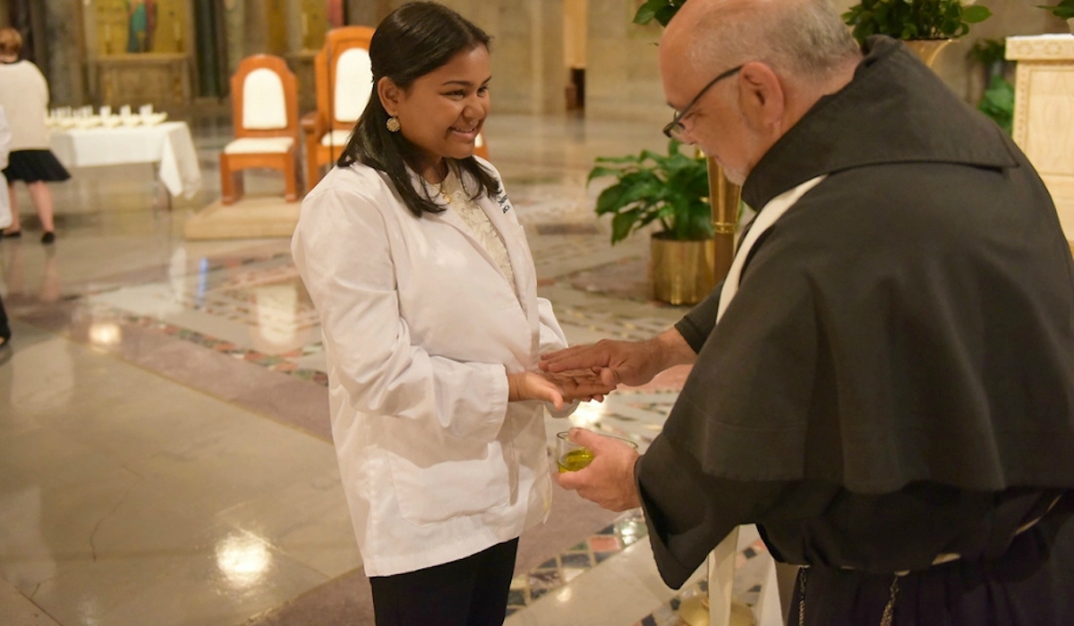 nursing student's hands being blessed at the annual blessing of the hands ceremony