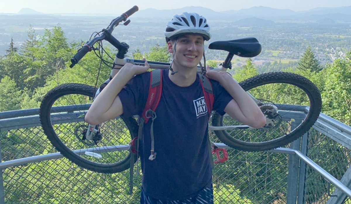 Sean O'Grady holding mountain bike