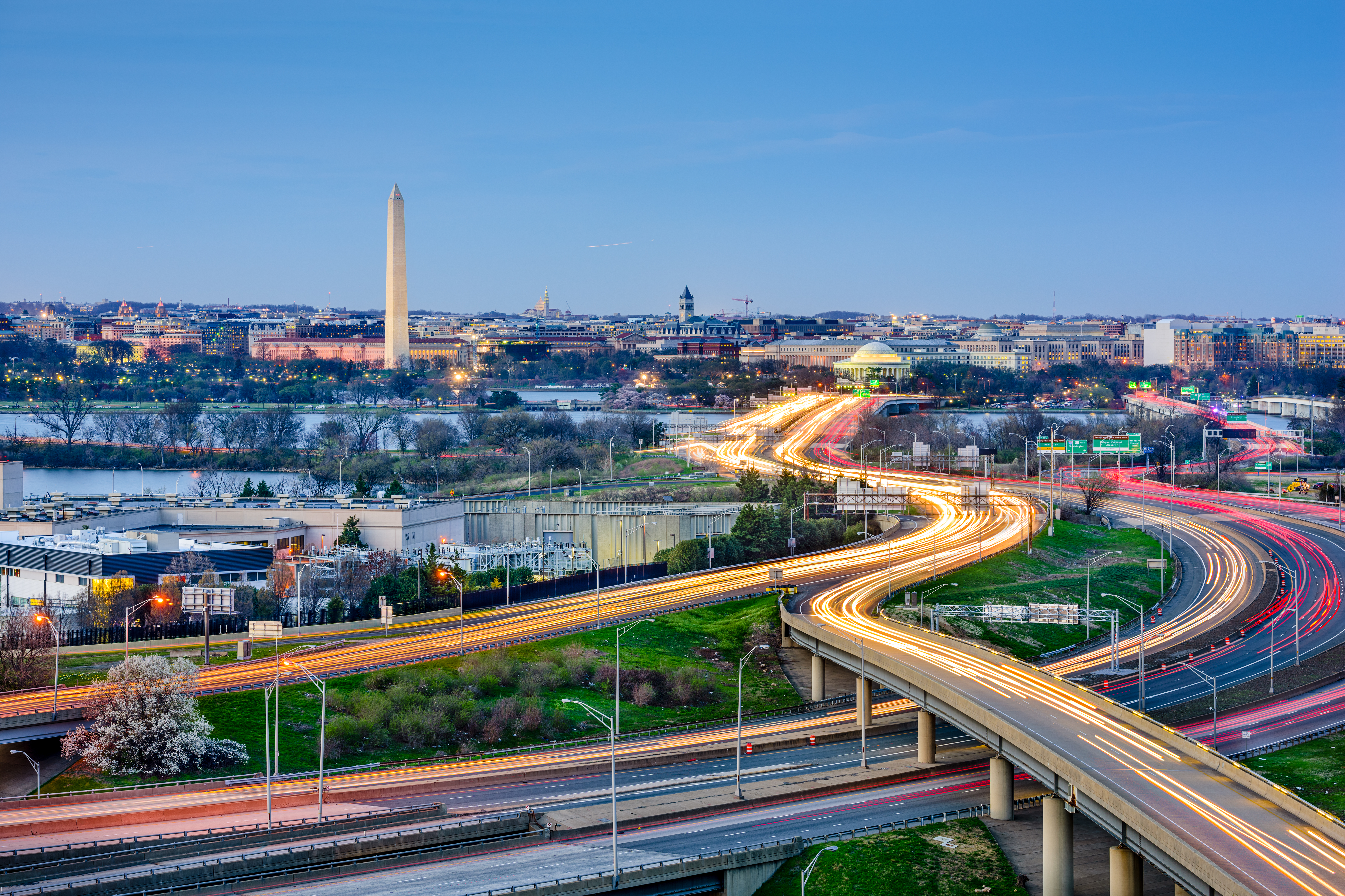 Aerial view of DC with monument and highway in the evening