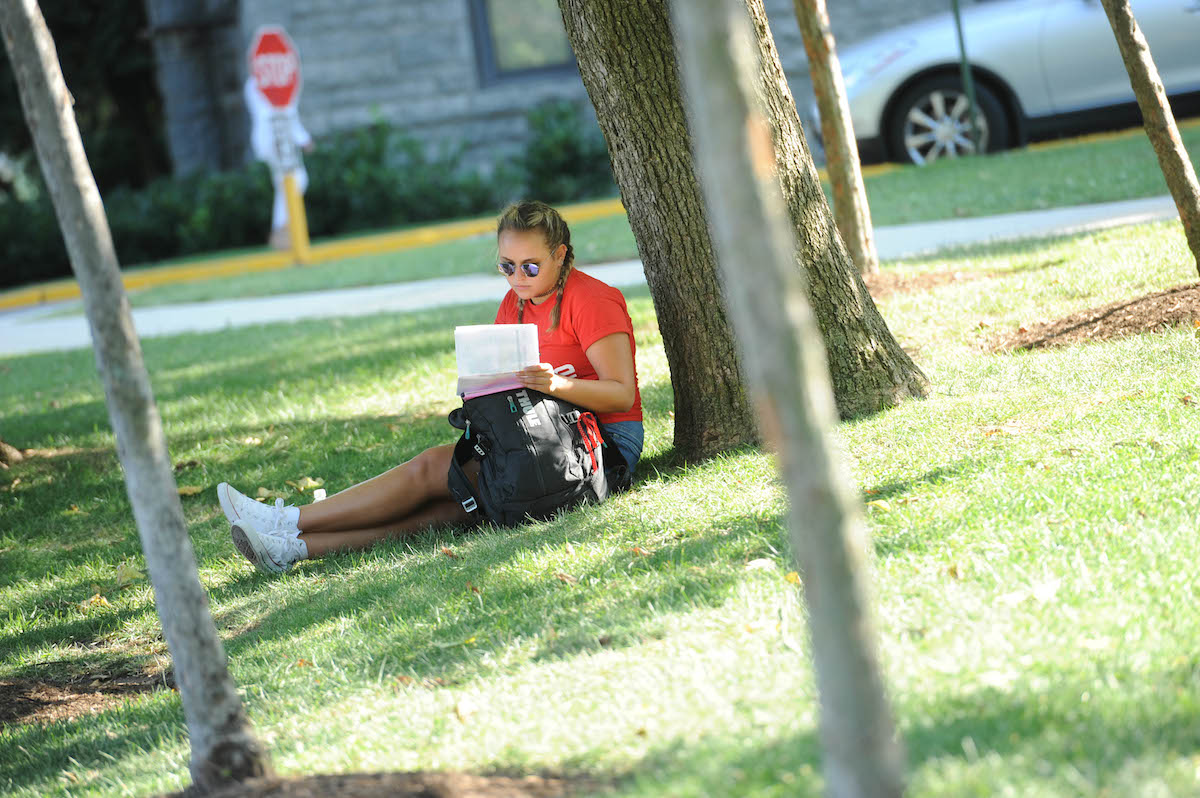 Student reading outside