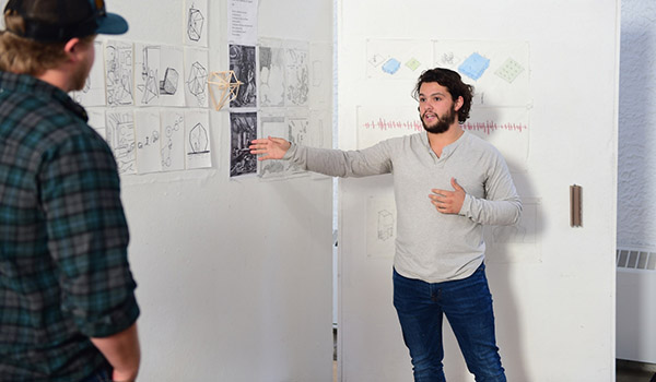 An architecture student presenting his work to the class.