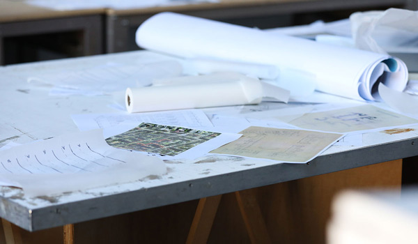 Drafting table covered with papers