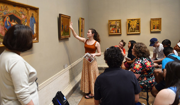 Professor and students studying art in the National Gallery of Art in Washington, D.C.