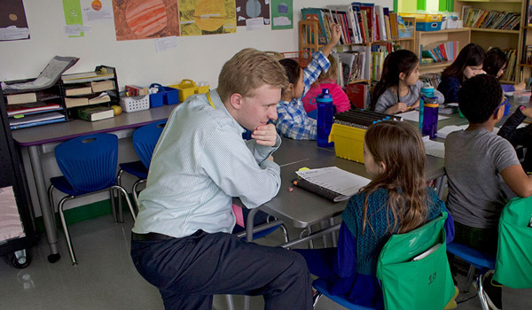 A Catholic University student in an elementary school classroom getting hands-on experience.