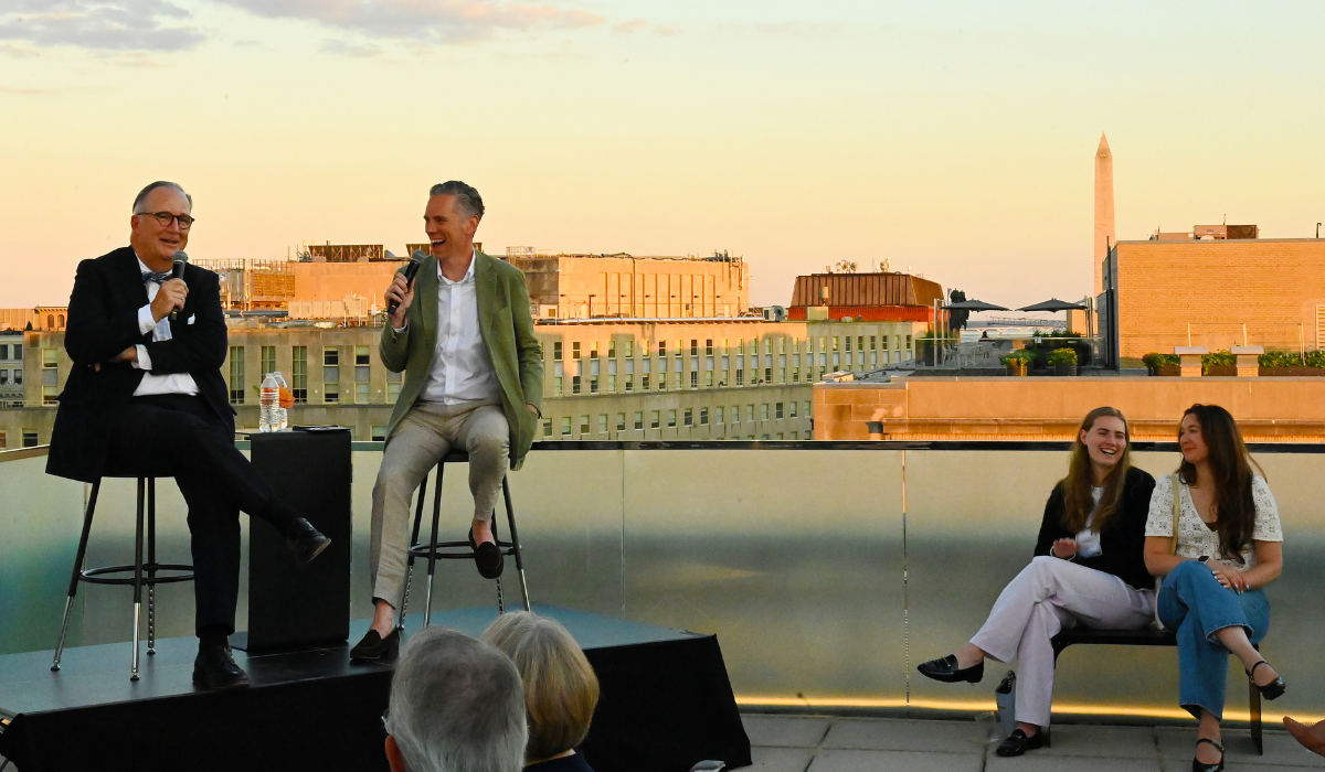James McCrery speaking at sunset event on rooftop
