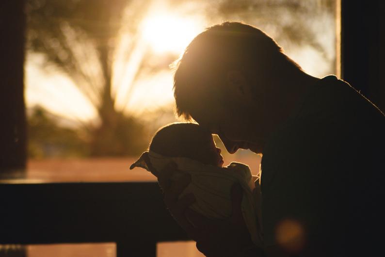 dad snuggling with baby