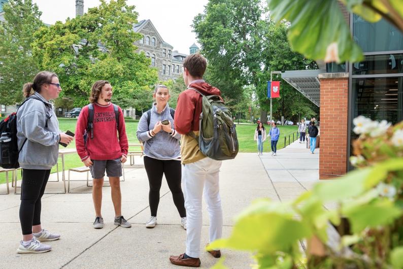 students talking together outside of a university building
