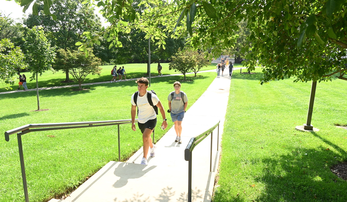 students walking to class on our green campus